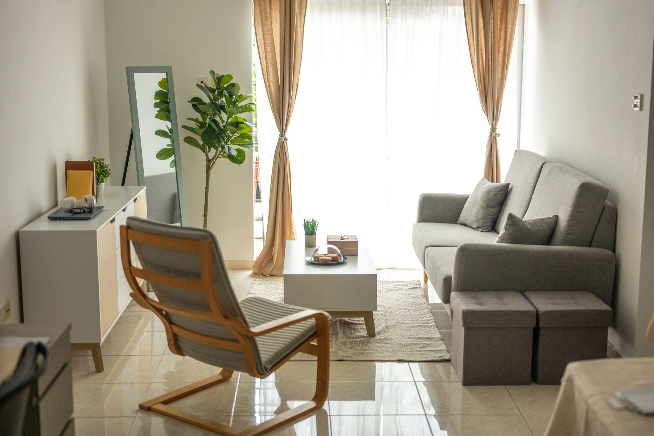 Refined neutral living room with sofa, armchair, and styled coffee table